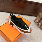 Unisex casual sneakers, black upper with tan toe panel, white sole with raised tread