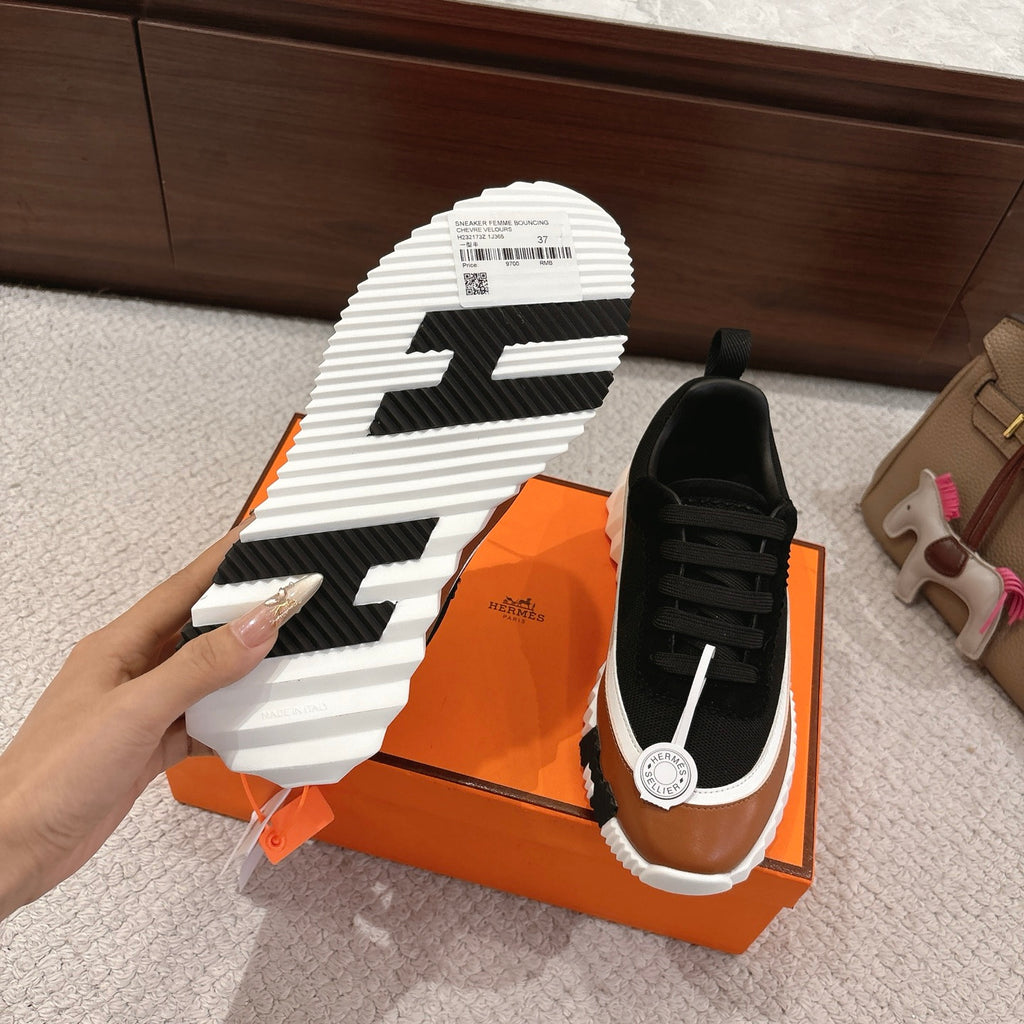 Unisex sneaker outsole view with black tread lines and white striped sole, pair shown