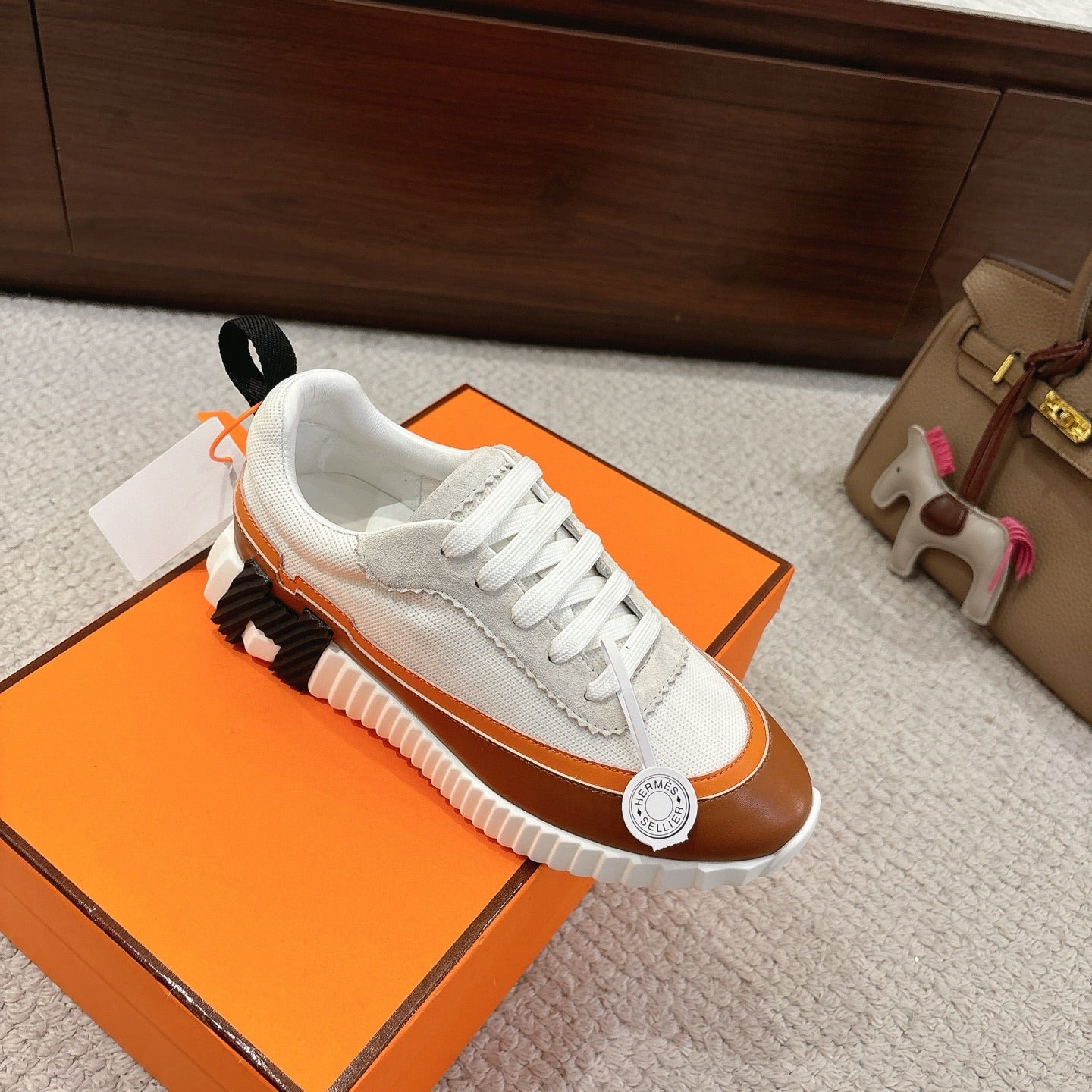 Hermes unisex luxury sneakers, white upper with brown trim and black accent on sole