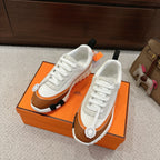Hermes unisex luxury shoes with white laces and brown trim, chunky tread sole
