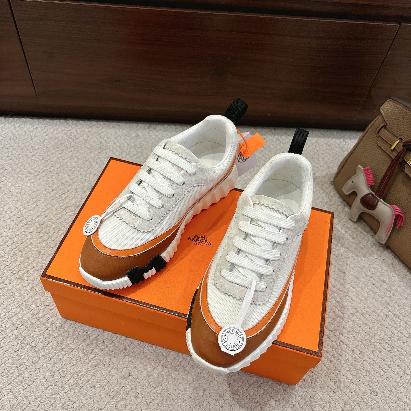 Hermes unisex luxury shoes with white laces and brown trim, chunky tread sole