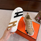 Hermes sneakers outsole view in black and white with label on box