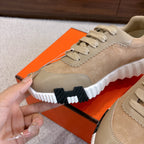 Beige sneaker with suede upper, lace-up and thick white outsole with dark tread