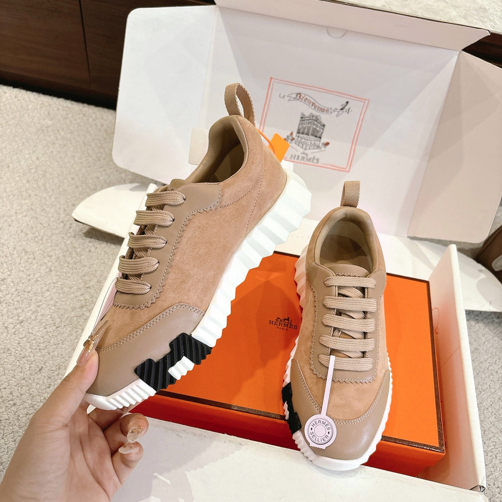 Hermes unisex sneakers with beige suede panels, cream laces, and chunky white tread sole.