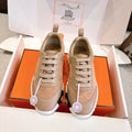 Hermes unisex sneakers in beige and tan suede/leather with lace-up front and rubber sole.