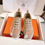 Hermes unisex sneakers in beige and tan suede/leather with lace-up front and rubber sole.