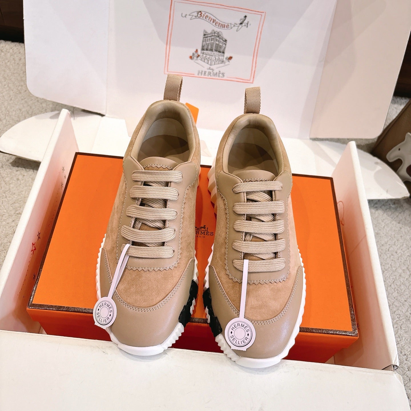 Hermes unisex sneakers in beige and tan suede/leather with lace-up front and rubber sole.