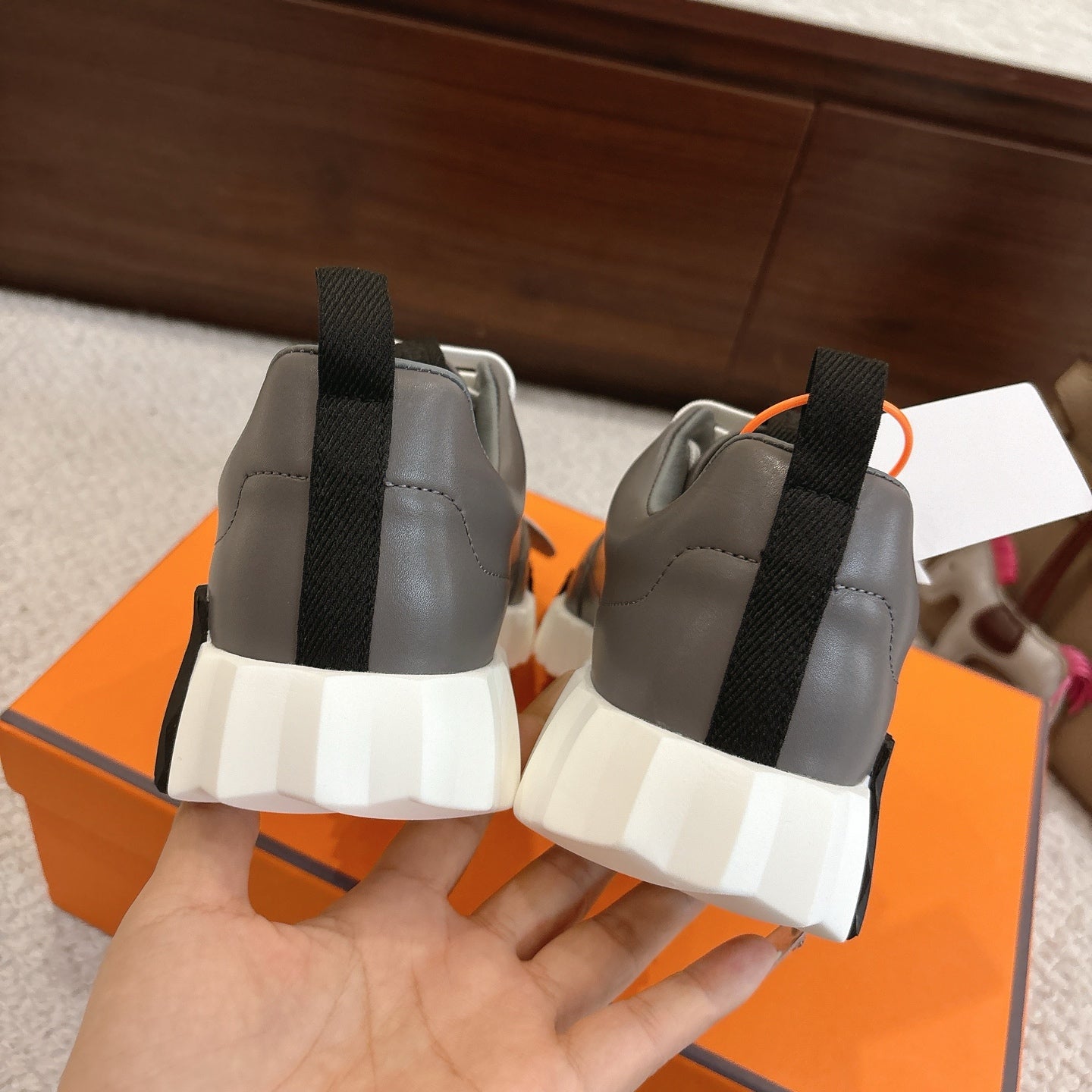 Hermes gray sneakers back view with elastic pull tabs and thick white sole