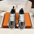 Hermes unisex sneakers in gray with white laces, black side panels, chunky white sole