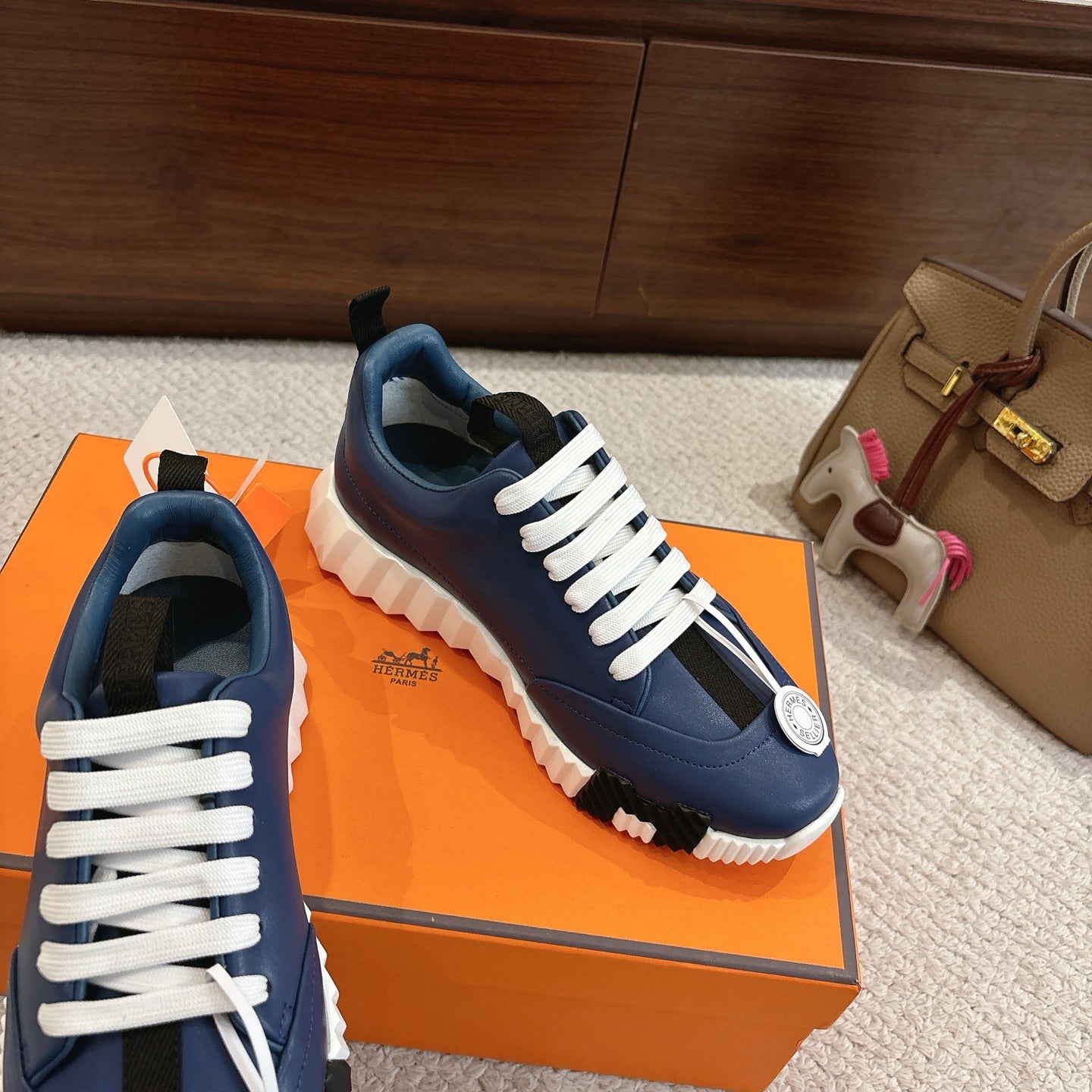 Blue sneakers with white laces and thick white sole, shown from a side angle