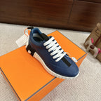 Blue low-top sneakers with white lace-up design and chunky white tread sole