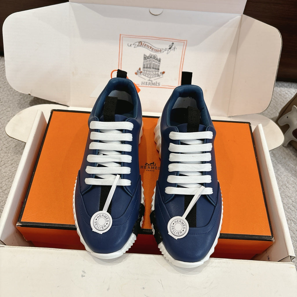 Blue low-top sneakers with white lace-up front and textured white rubber sole