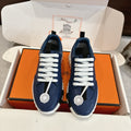 Blue low-top sneakers with white lace-up front and textured white rubber sole