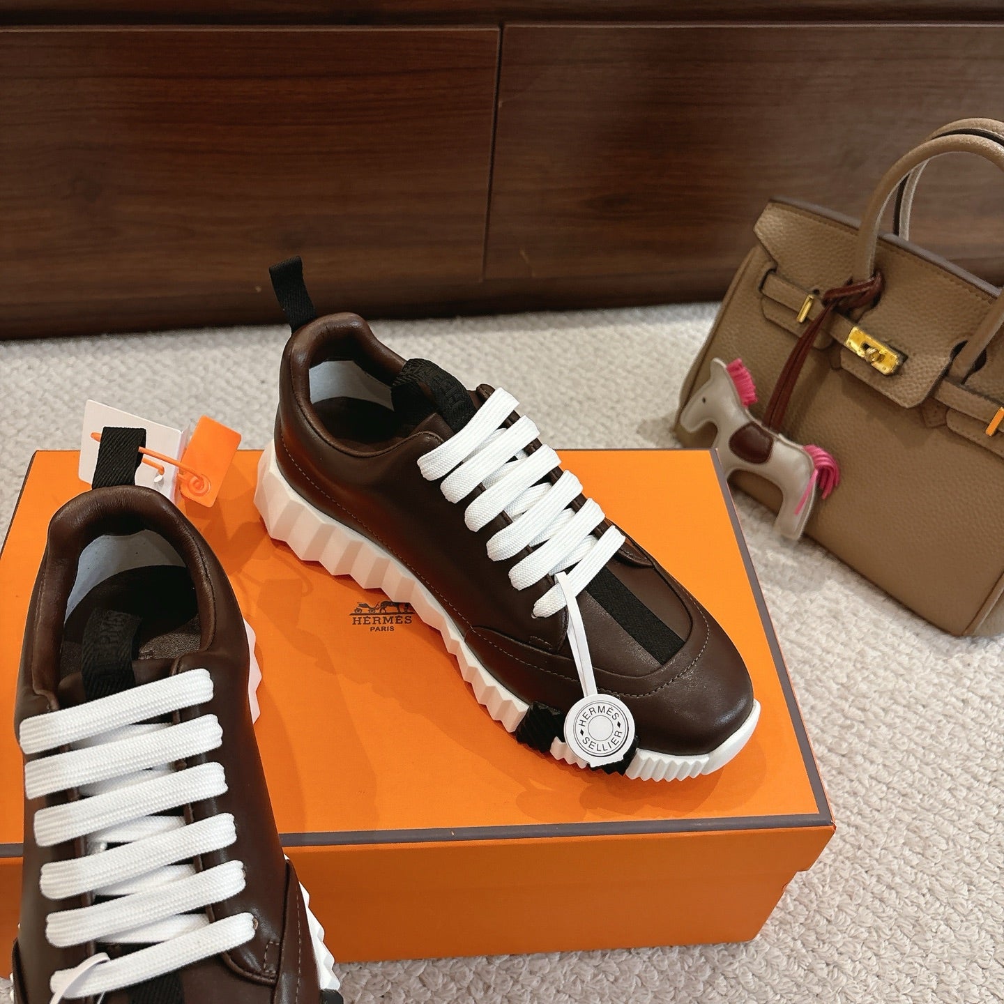 Hermes unisex luxury shoes, dark brown leather, white laces, thick rubber sole view
