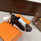 Hermes unisex luxury shoes, dark brown leather, white laces, single shoe on box
