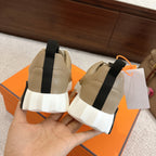 Beige unisex sneakers from back view with black heel tab and chunky white outsole.