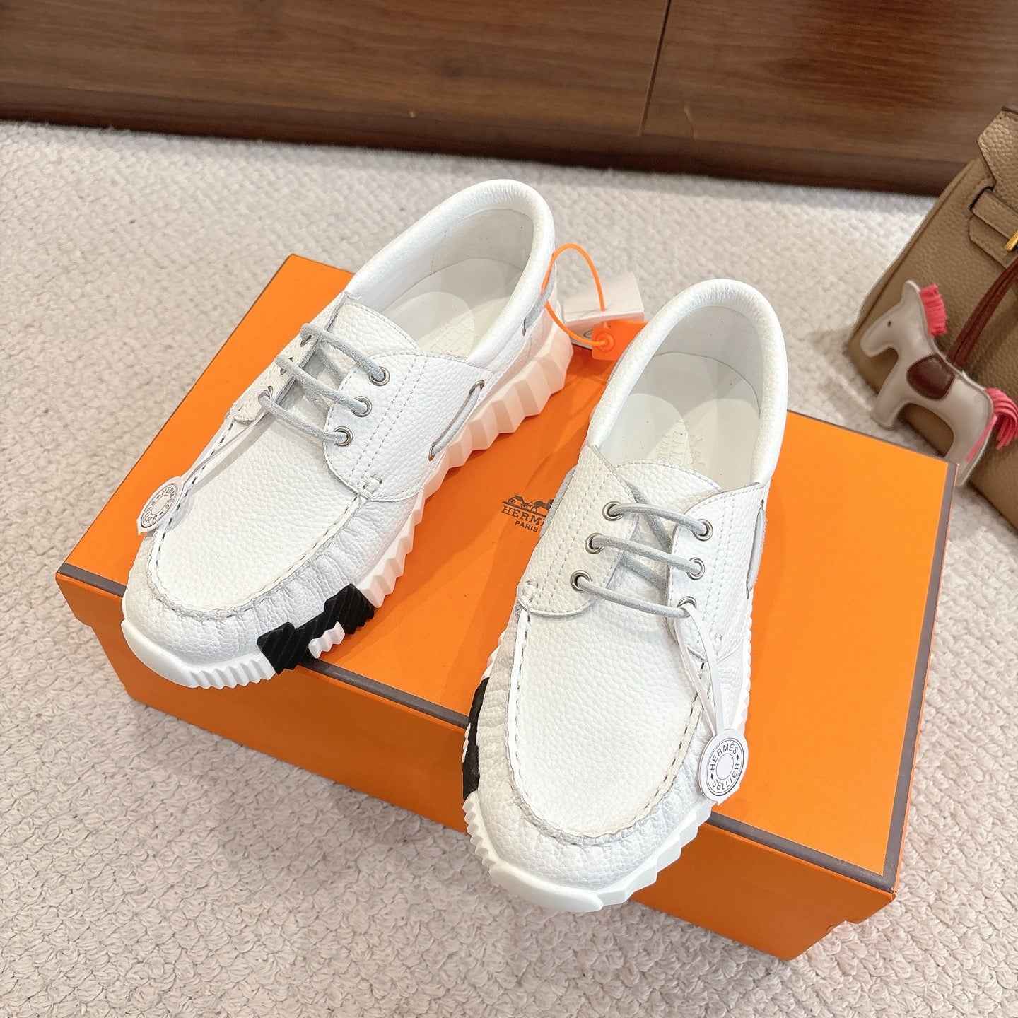 Pair of white leather sneakers with chunky ridged soles and lace-up fronts