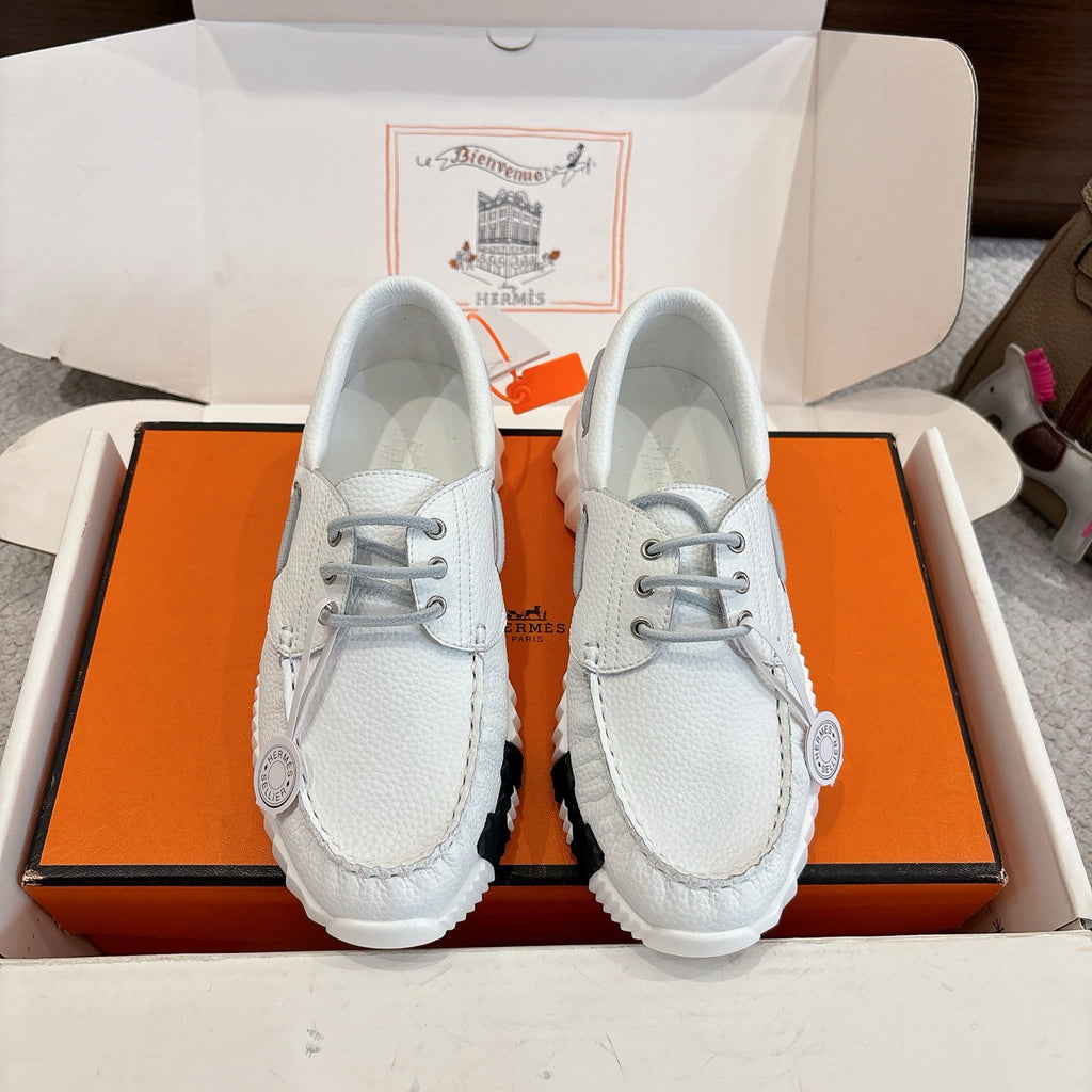 Unisex white leather sneakers with gray laces and ridged rubber sole