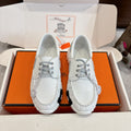 Unisex white leather sneakers with gray laces and ridged rubber sole