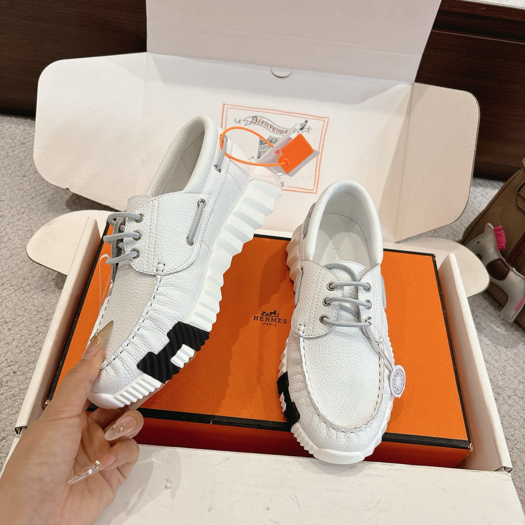 Unisex white leather sneakers with side stripe detail and gray lace-up front