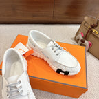 White lace-up sneaker with textured leather upper and chunky ridged sole