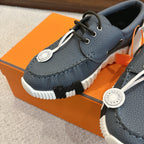 Close-up of blue textured leather lace-up sneaker with white sole and round logo charm
