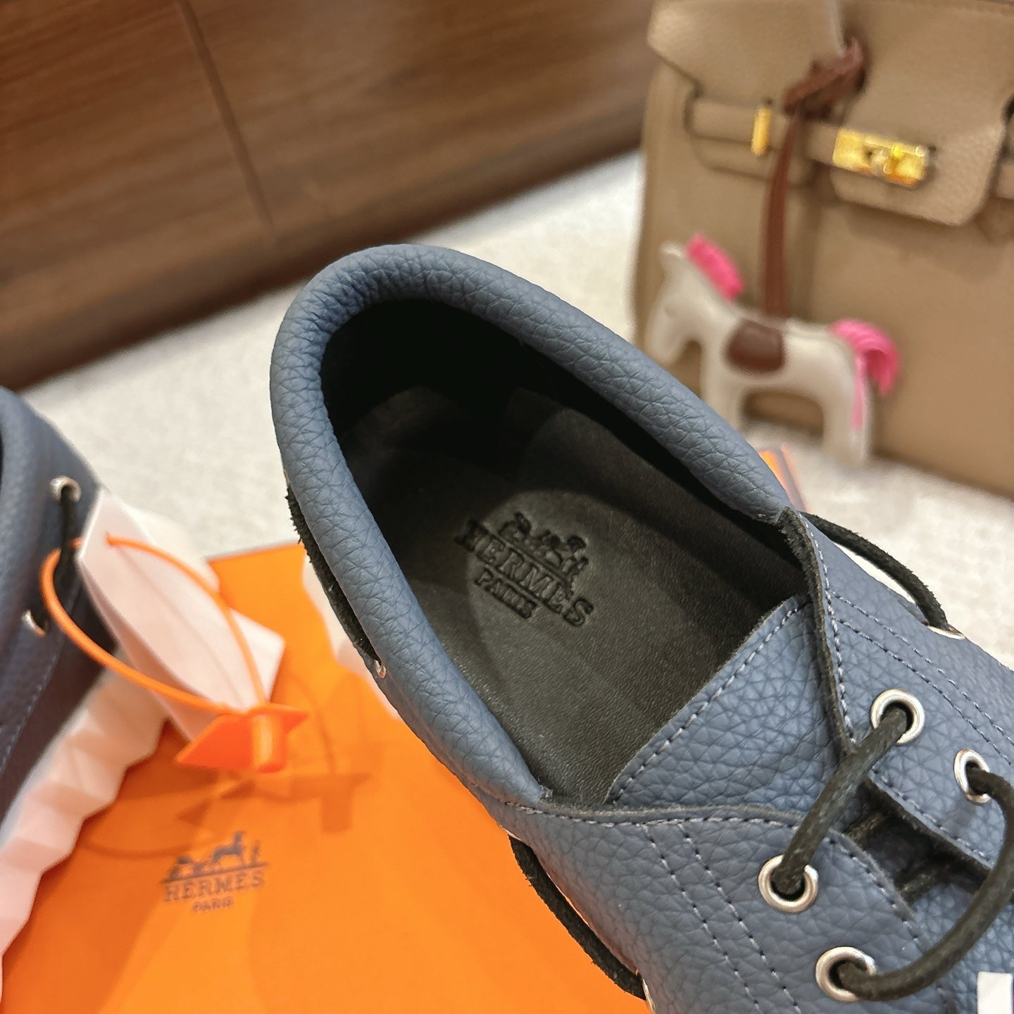 Blue leather sneaker upper with lace-up eyelets and cushioned interior lining