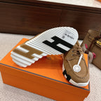 Tan suede lace-up sneaker showing outsole with white ridged tread and black stripe