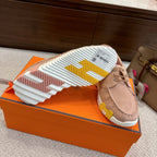 Outsole view of beige lace-up shoes with multicolor tread and ridged grip