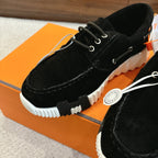 Black lace-up unisex shoe close-up, white chunky sole and laces