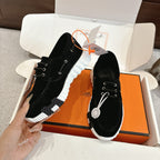 Black lace-up unisex shoes with white ridged sole, side stitching detail