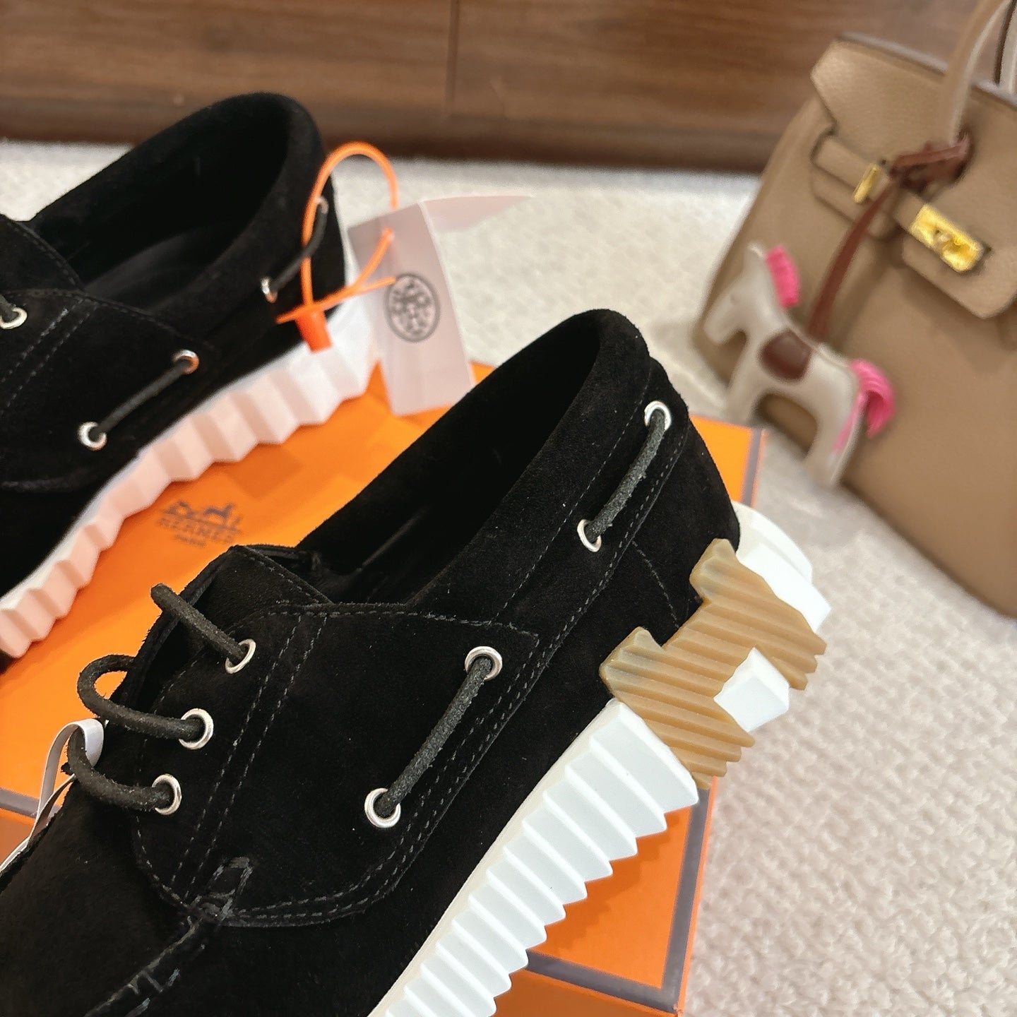 Black lace-up unisex shoes, side view showing white ridged tread