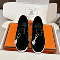 Black lace-up unisex shoes with padded collar and chunky white ridged sole