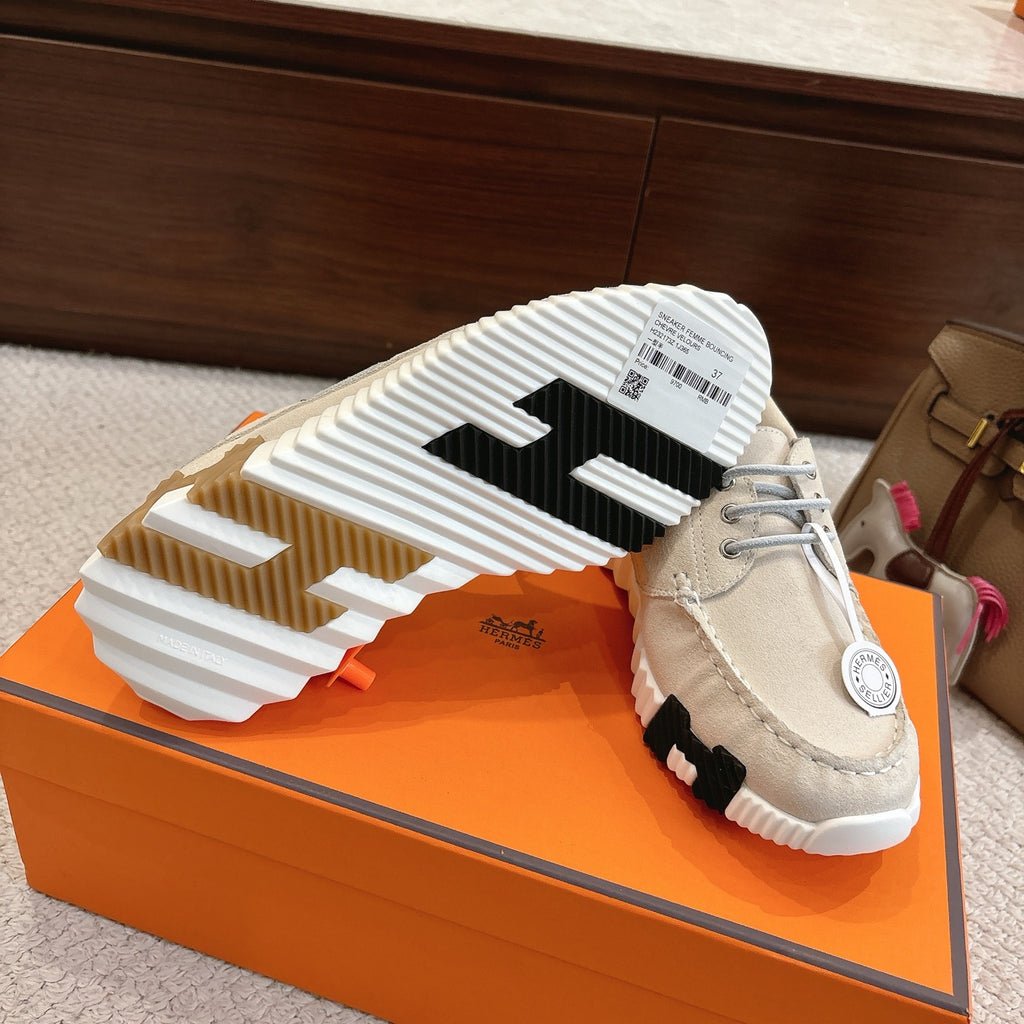 Light beige sneakers with white and brown outsole tread, side profile view