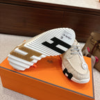 Light beige sneakers with white and brown outsole tread, side profile view