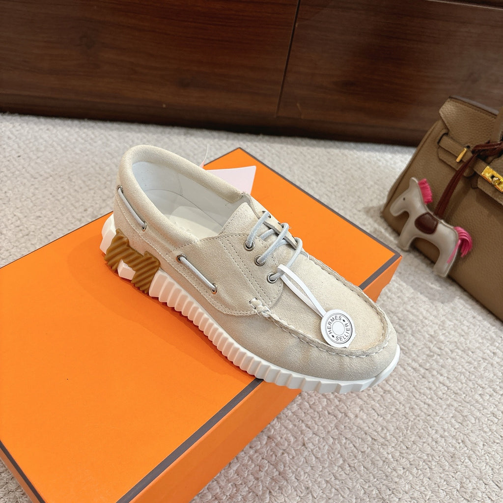 Light beige lace-up sneakers with textured heel and ribbed outsole tread
