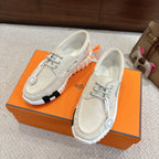 Pair of light beige lace-up sneakers with chunky ribbed tread soles