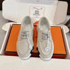 Light beige lace-up shoes with round eyelets and stitched moccasin seams