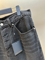 Dark blue denim pants waist detail with front button and pocket openings