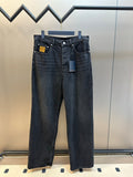 Dark blue denim pants with front button-and-zip closure and belt loops