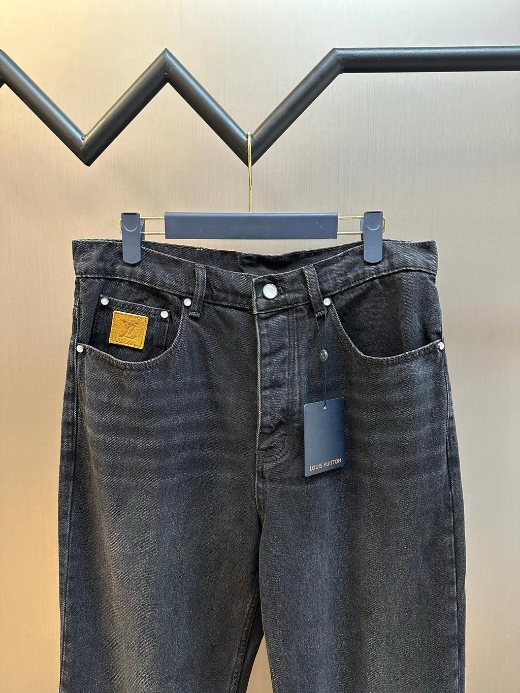 Dark blue denim pants with two front pockets and waistband button closure