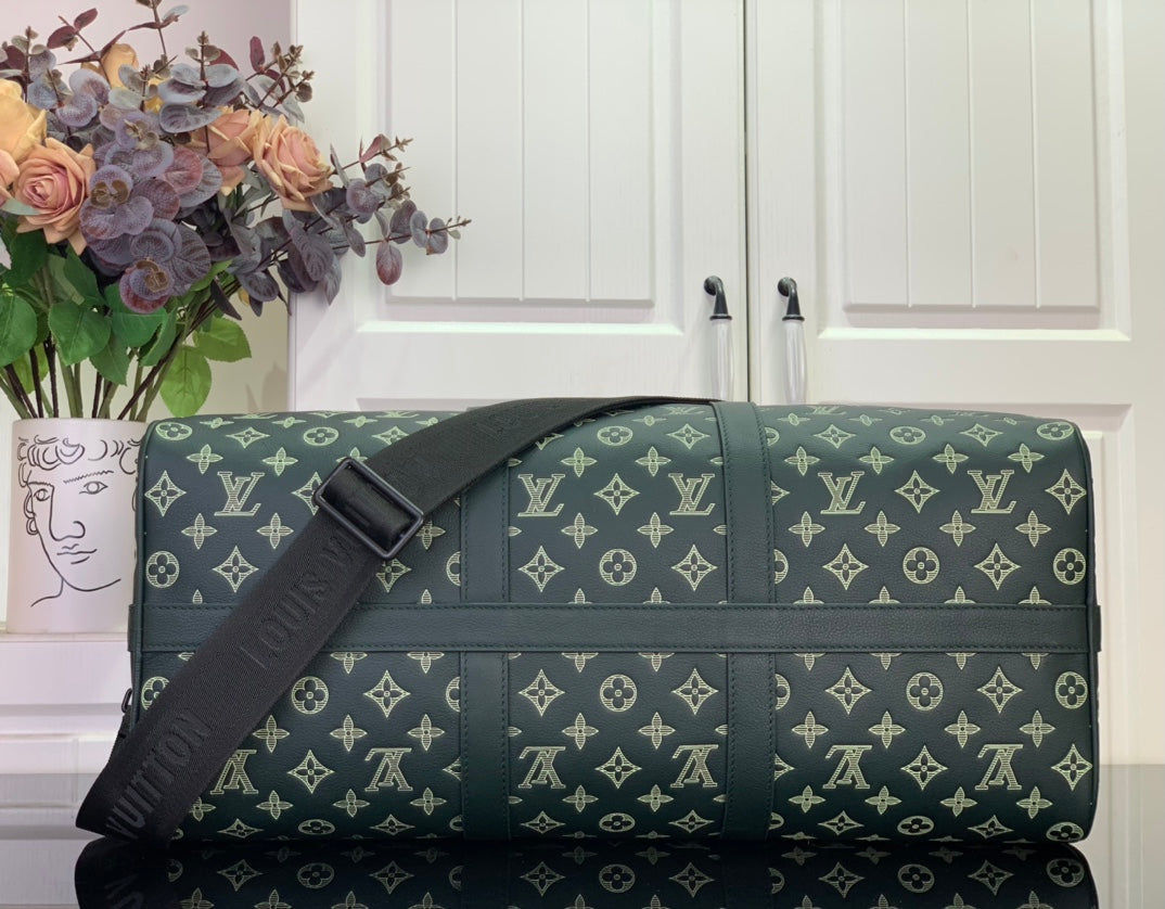Louis Vuitton duffel bag with crossbody strap and gold monogram on dark green