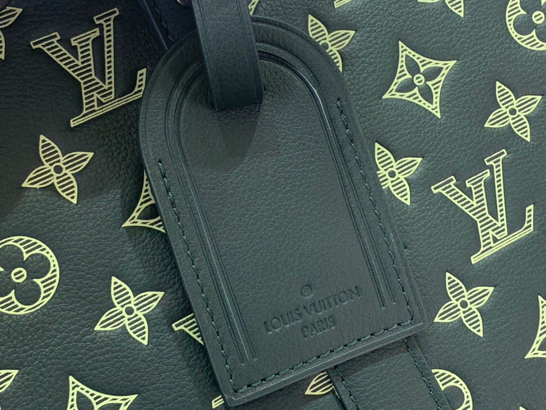 Louis Vuitton luggage tag on dark green leather with embossed brand name