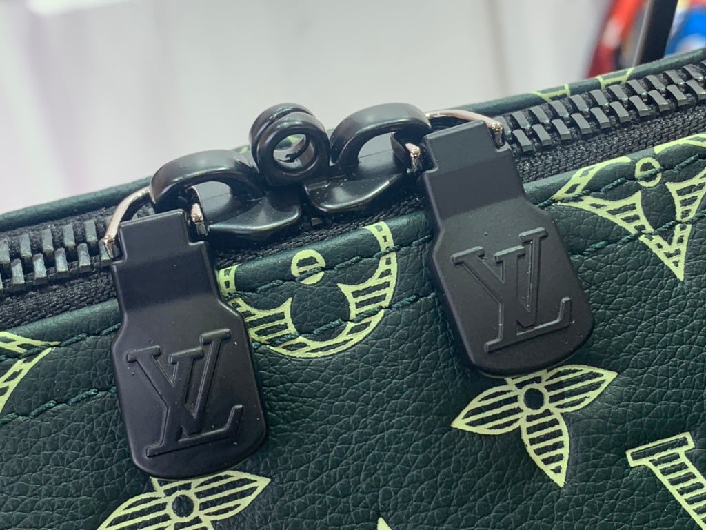 Louis Vuitton zipper pulls and tab hardware on dark green bag with gold monogram