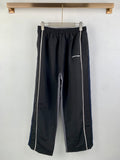 Balenciaga track pants, dark with white side stripes and elastic waistband