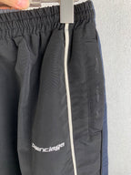 Balenciaga track pants close-up: elastic waistband and front logo patch
