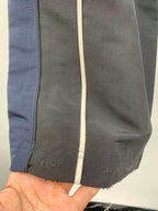Balenciaga track pants close-up: stitched seam, pocket edge and hem