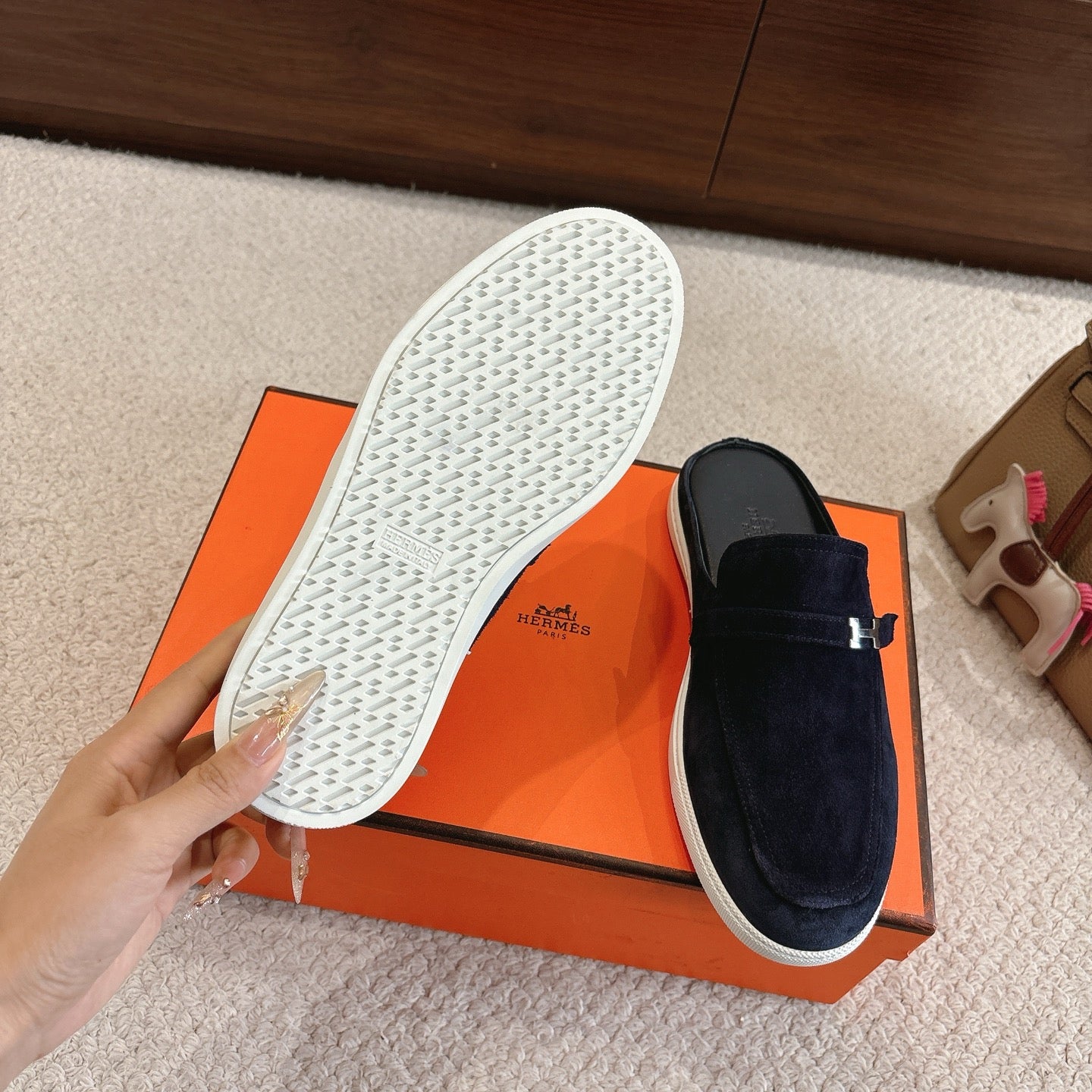 Hermes unisex suede loafer outsole view, dark blue upper with white textured bottom.