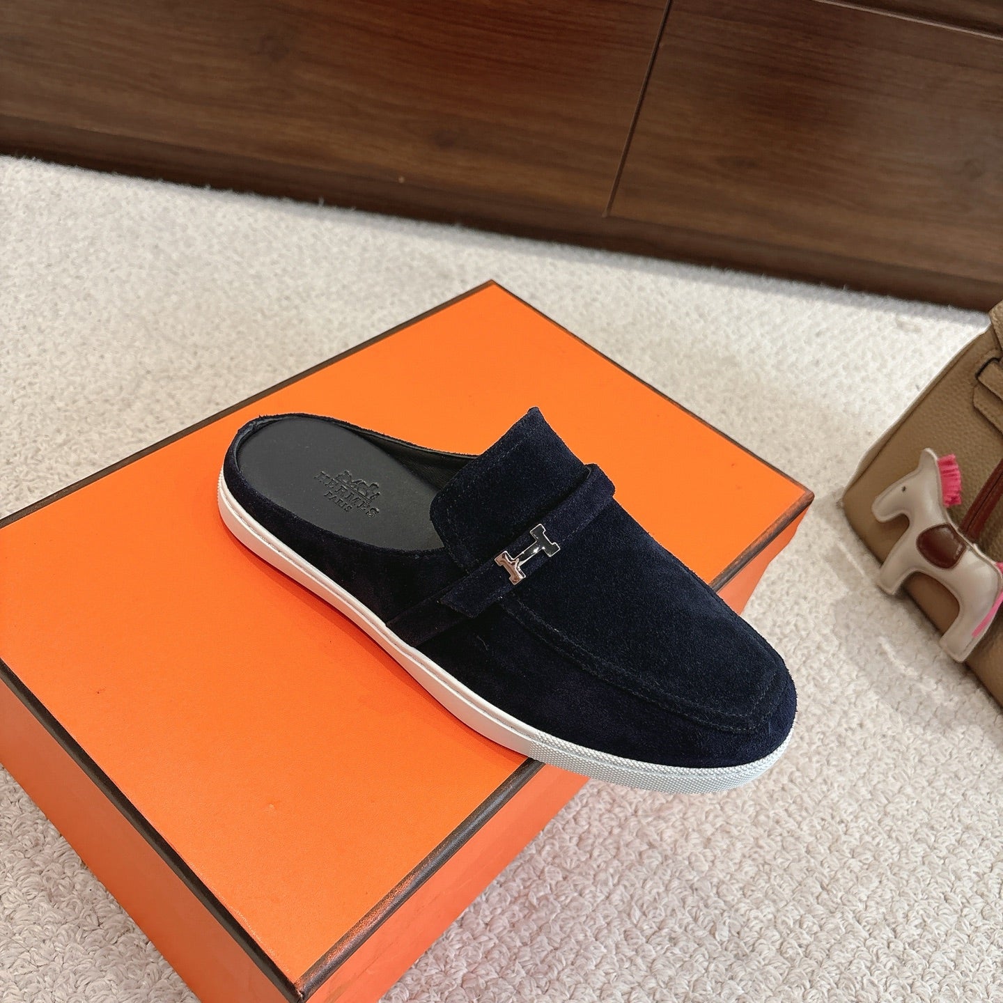 Hermes unisex loafer, dark blue upper with H buckle strap and white sidewall sole.