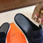 Hermes unisex suede loafers, dark blue slip-on design with H buckle and white edge sole.